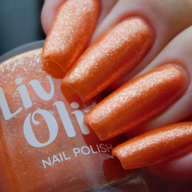 Closeup of nails painted in Coral orange nail polish