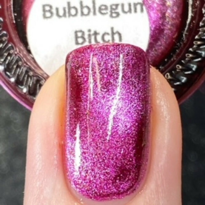 close up of a glass bottle with pink & silver vegan nail polish