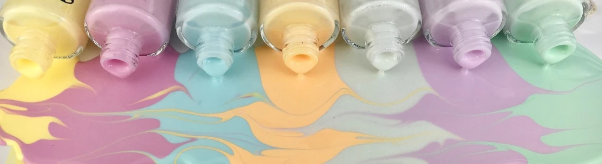 7 pastel shades nail polish pouring out of bottles